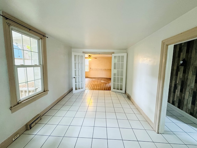 interior space with french doors and light tile patterned floors