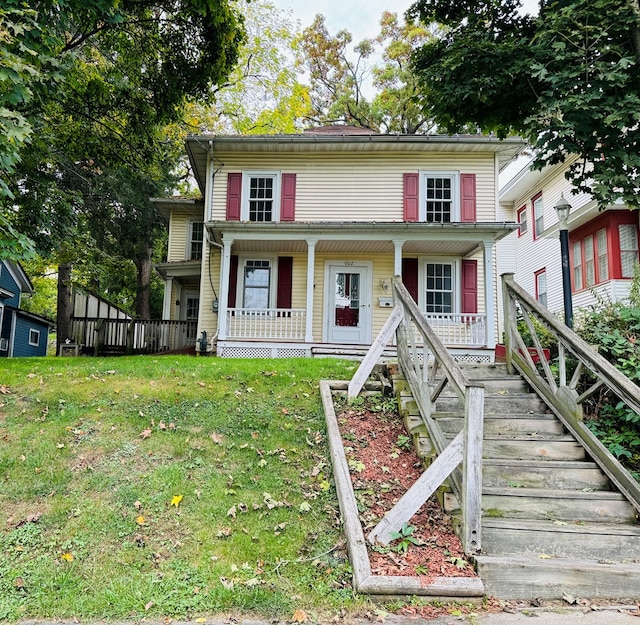 view of front of property featuring a porch and a front yard