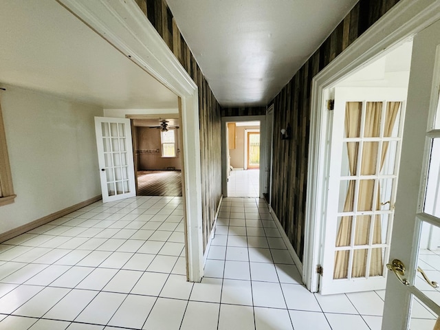 hall with french doors and light tile patterned floors