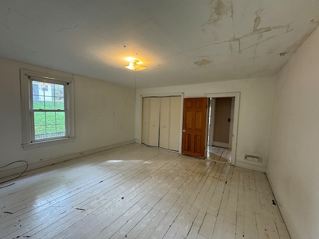 unfurnished bedroom with light wood-type flooring