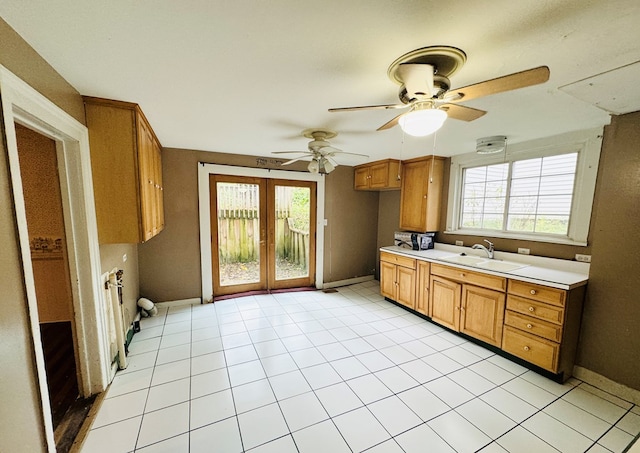 kitchen with ceiling fan, sink, light tile patterned flooring, and french doors