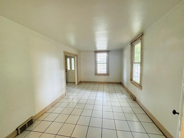 unfurnished room featuring light tile patterned floors