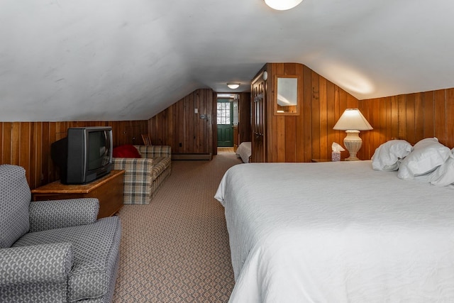 carpeted bedroom with lofted ceiling and wood walls