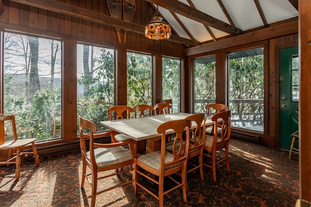 sunroom featuring vaulted ceiling with beams