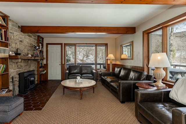 living area with beamed ceiling and wainscoting