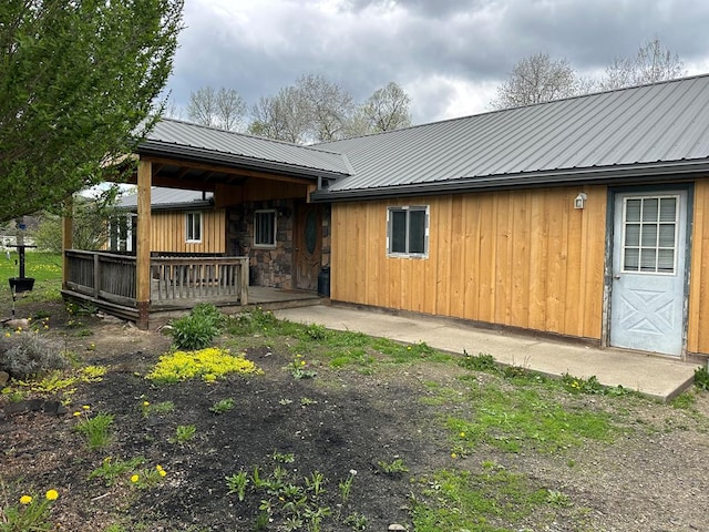 146 Academy St, Genesee, PA 16923 - back of house featuring metal roof, stone siding, and a deck