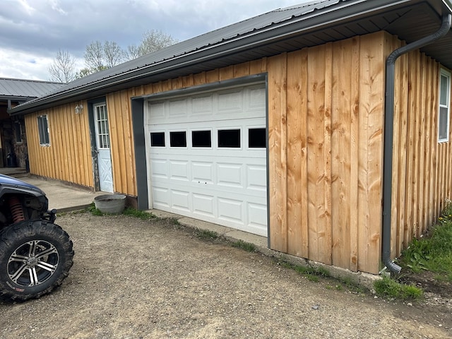 146 Academy St, Genesee, PA 16923 - view of home's exterior featuring metal roof, driveway, and board and batten siding