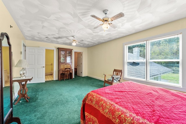 bedroom featuring dark colored carpet and ceiling fan