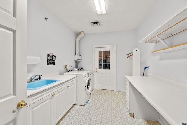 laundry area with cabinets, sink, and washing machine and dryer