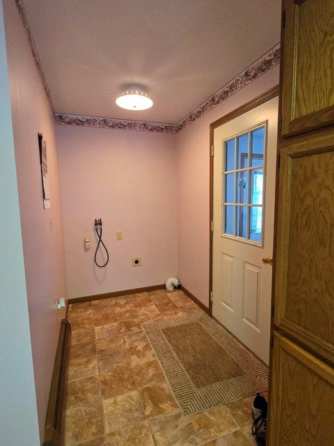 laundry area featuring electric dryer hookup and a baseboard heating unit