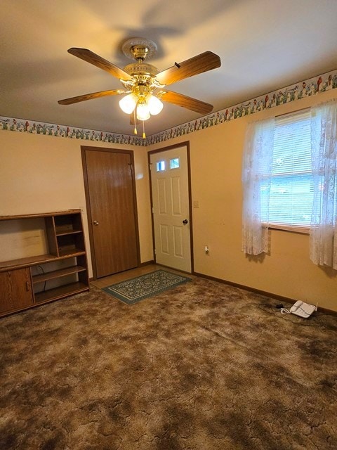 carpeted entrance foyer with ceiling fan