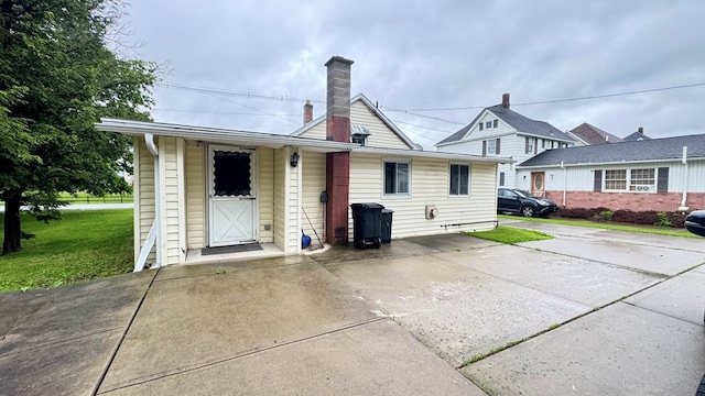 128 Bradford St, Sayre, PA 18840 - back of house with a lawn and a chimney