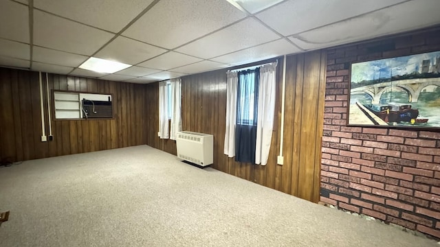 128 Bradford St, Sayre, PA 18840 - below grade area with a paneled ceiling, carpet flooring, wood walls, and heating unit