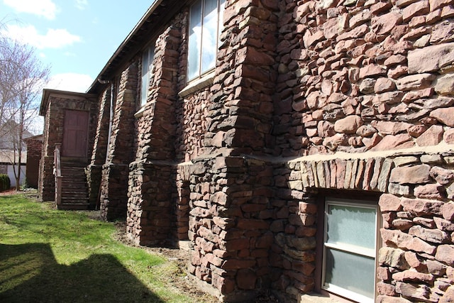 view of side of home featuring a lawn