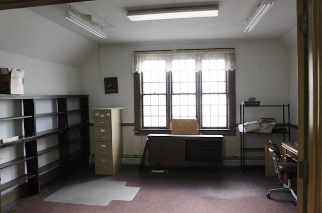 home office with lofted ceiling and dark colored carpet