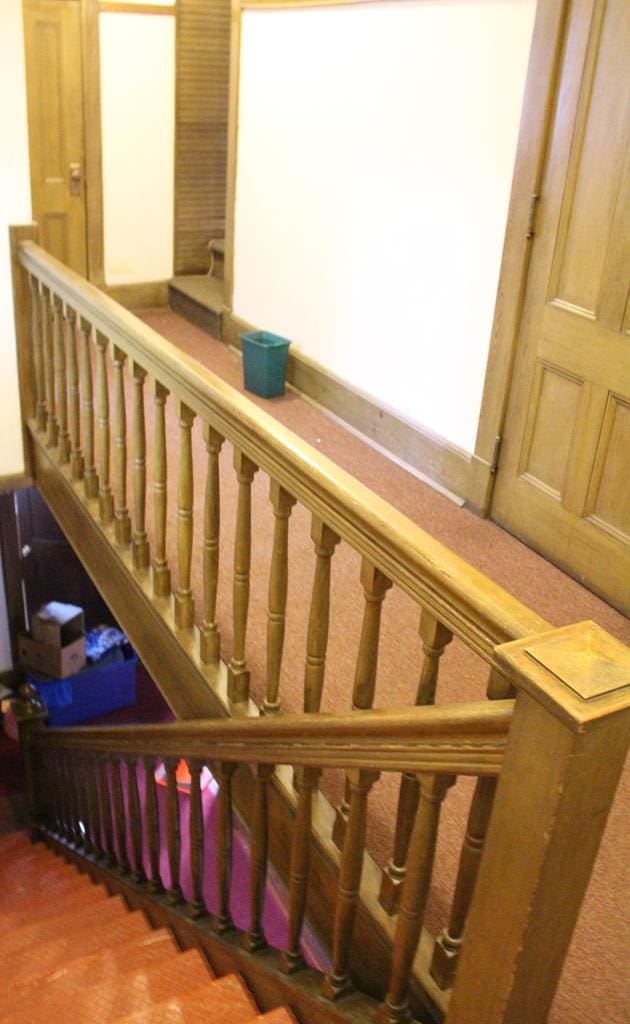 stairs featuring hardwood / wood-style floors