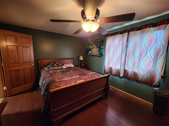 bedroom with dark hardwood / wood-style floors and ceiling fan