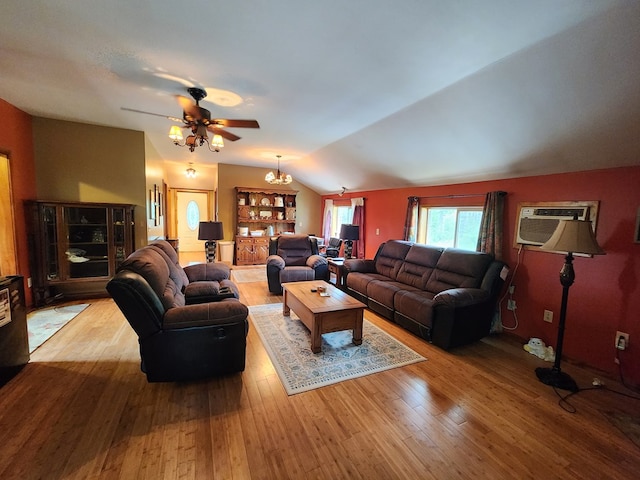 living room with hardwood / wood-style flooring, ceiling fan with notable chandelier, a wall unit AC, and vaulted ceiling