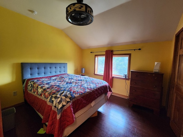 bedroom featuring dark hardwood / wood-style flooring and lofted ceiling