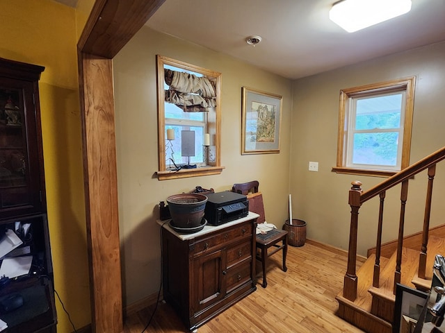 home office with light hardwood / wood-style flooring