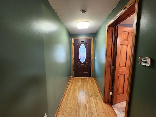 doorway to outside with light wood-type flooring