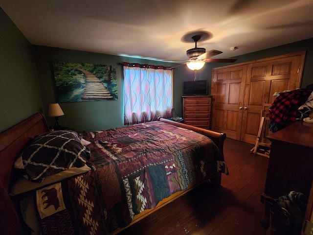 bedroom with ceiling fan, a closet, and dark hardwood / wood-style floors