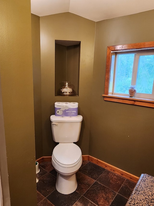 bathroom with toilet and lofted ceiling