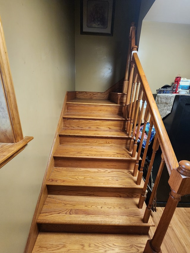 stairs with hardwood / wood-style flooring