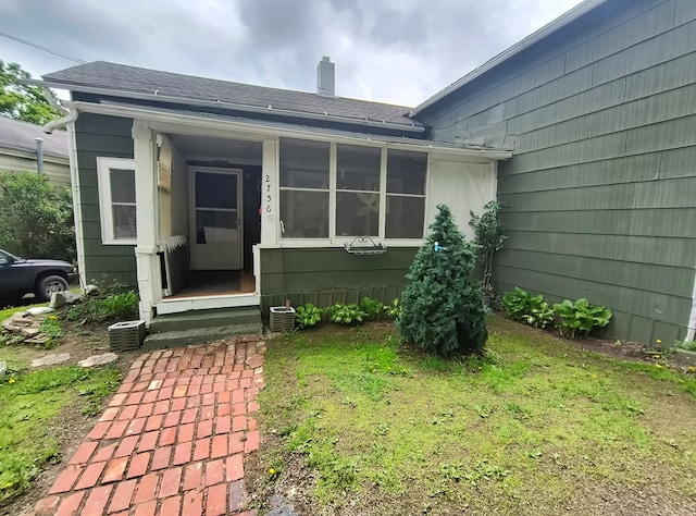 2756 Austinville Rd, Troy, PA 16947 - doorway to property with a chimney, a shingled roof, a yard, and central AC