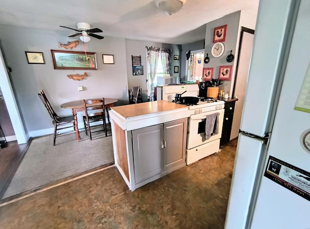 2756 Austinville Rd, Troy, PA 16947 - kitchen with white appliances, ceiling fan, a peninsula, and light countertops
