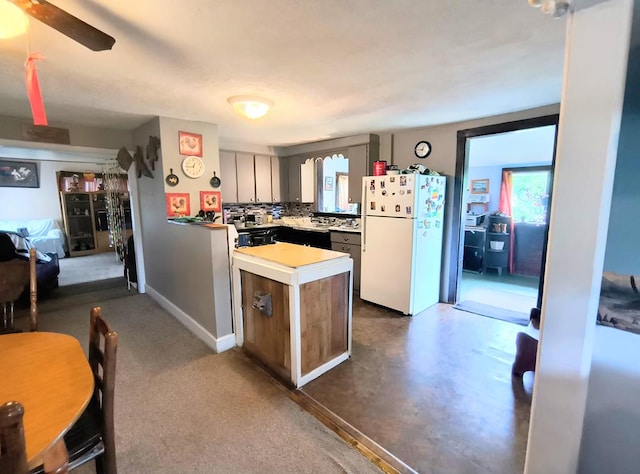 2756 Austinville Rd, Troy, PA 16947 - kitchen featuring freestanding refrigerator, light countertops, a peninsula, decorative backsplash, and ceiling fan