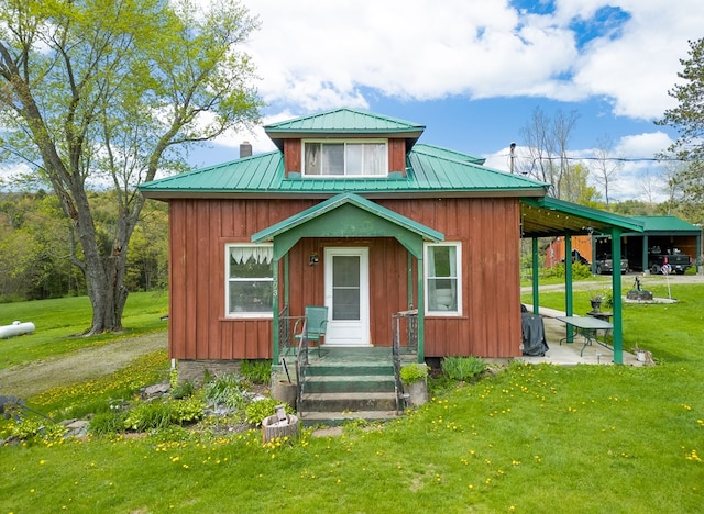 1503 Stewart Rd, Addison, NY 14801 - view of front of property featuring metal roof, a front yard, and board and batten siding