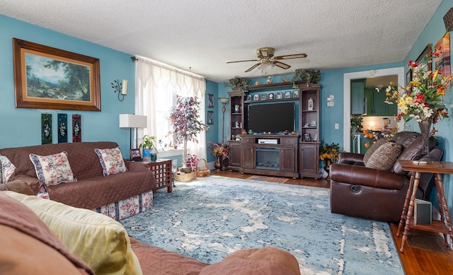 1503 Stewart Rd, Addison, NY 14801 - living area featuring wood finished floors, ceiling fan, and a textured ceiling