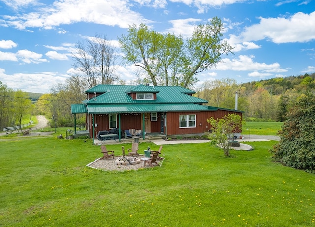 1503 Stewart Rd, Addison, NY 14801 - rear view of house with a fire pit, a yard, metal roof, board and batten siding, and a porch