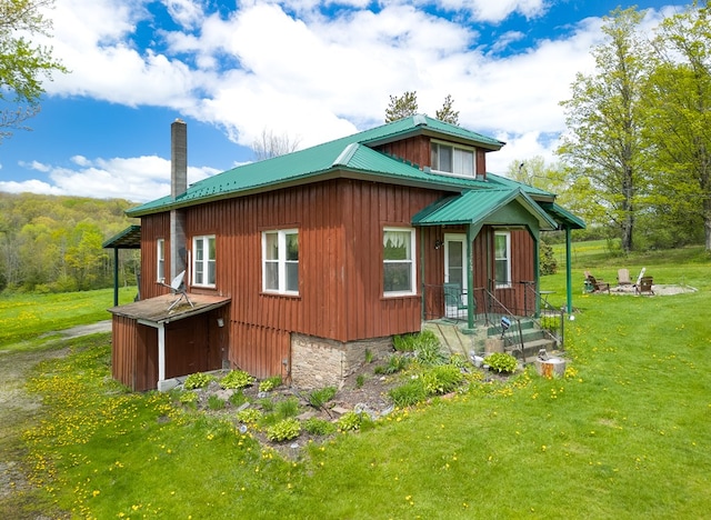 1503 Stewart Rd, Addison, NY 14801 - view of side of home with metal roof, a lawn, and a chimney