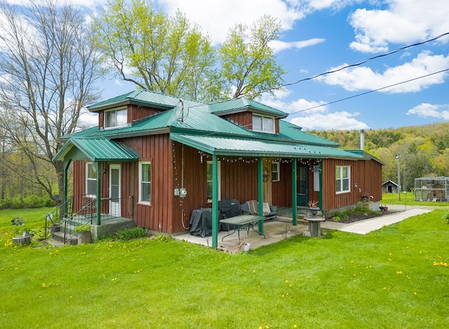 1503 Stewart Rd, Addison, NY 14801 - back of property with a lawn, board and batten siding, metal roof, and a patio