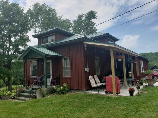 1503 Stewart Rd, Addison, NY 14801 - rear view of property with a patio, a lawn, metal roof, and board and batten siding
