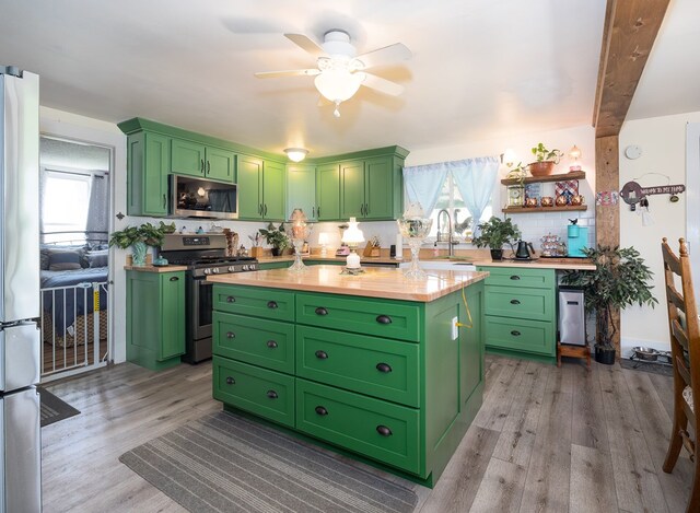 1503 Stewart Rd, Addison, NY 14801 - kitchen featuring stainless steel appliances, green cabinetry, healthy amount of natural light, and a center island