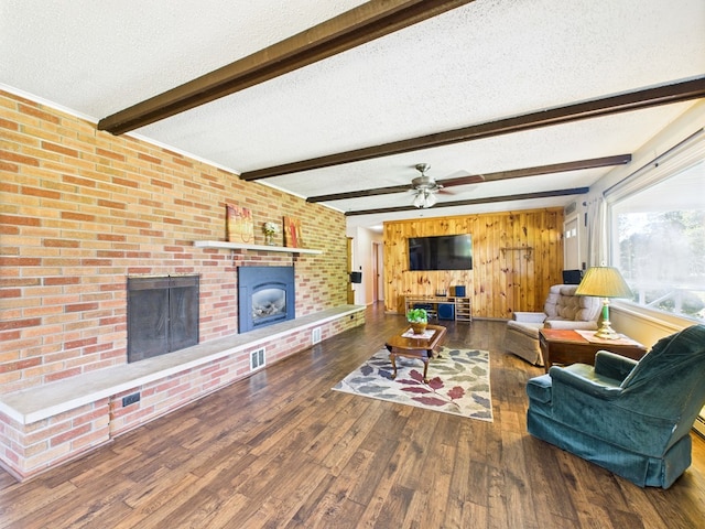 1041 Rte 44, Shinglehouse, PA 16748 - living area featuring a fireplace, a textured ceiling, wood finished floors, a ceiling fan, and beamed ceiling