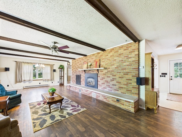1041 Rte 44, Shinglehouse, PA 16748 - living room featuring baseboard heating, a textured ceiling, wood finished floors, a fireplace, and beam ceiling