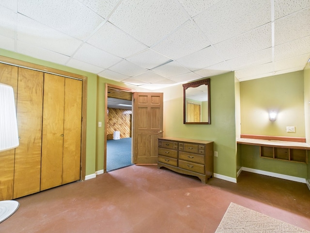 1041 Rte 44, Shinglehouse, PA 16748 - unfurnished bedroom featuring finished concrete flooring, a paneled ceiling, and a closet