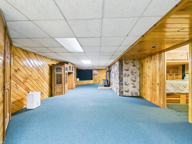 1041 Rte 44, Shinglehouse, PA 16748 - finished basement with carpet flooring, wood walls, a paneled ceiling, and a wood stove