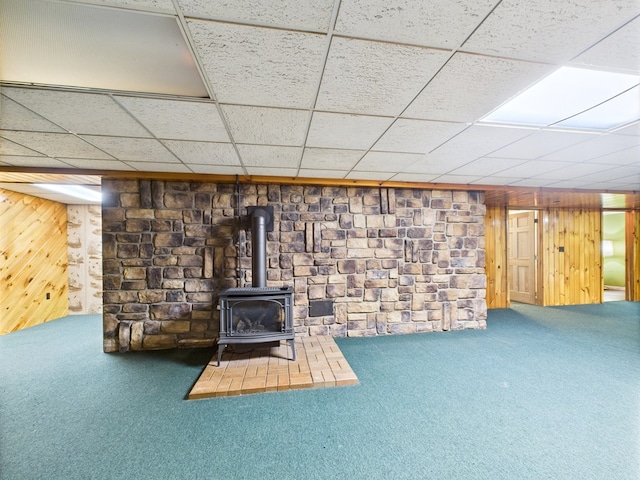 1041 Rte 44, Shinglehouse, PA 16748 - finished basement featuring a wood stove, carpet flooring, a drop ceiling, and wooden walls