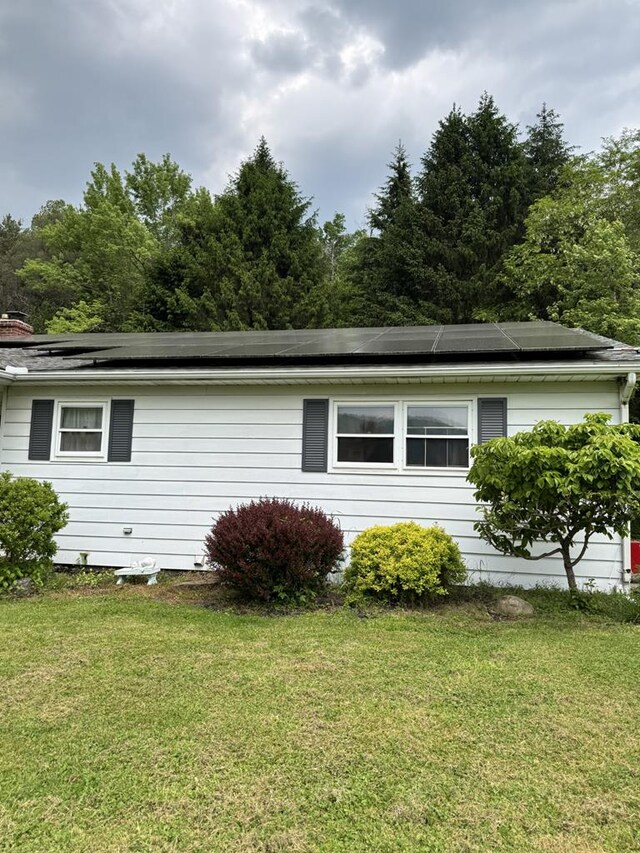 1041 Rte 44, Shinglehouse, PA 16748 - view of property exterior with a yard and roof mounted solar panels