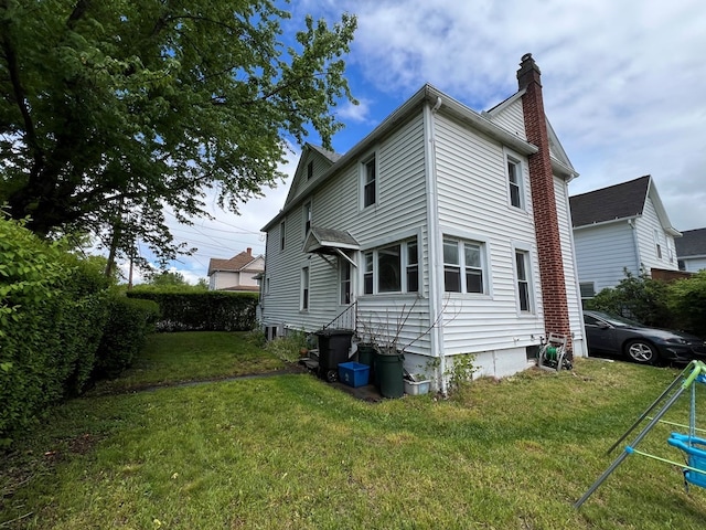 rear view of house with a lawn