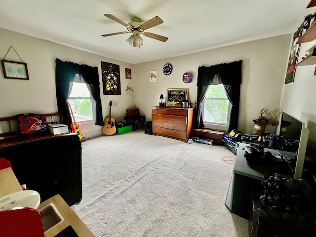 carpeted bedroom with multiple windows and ceiling fan