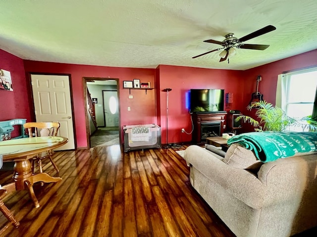 living room featuring dark hardwood / wood-style floors and ceiling fan