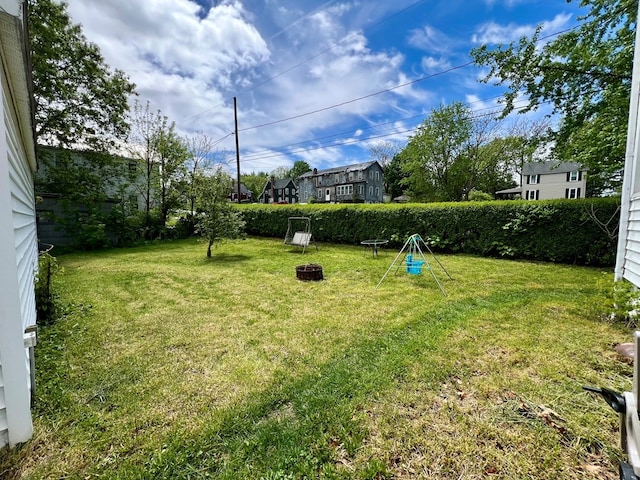 view of yard with an outdoor fire pit