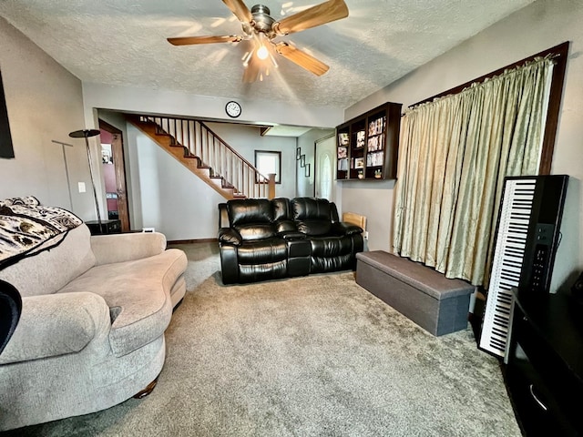 carpeted living room with ceiling fan and a textured ceiling