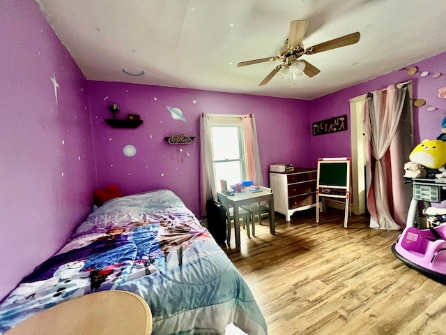 bedroom with light wood-type flooring and ceiling fan